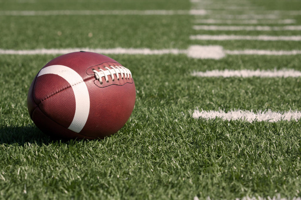 A football resting on a turf football field